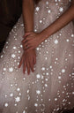 Close-up of a hand resting on a star tulle skirt, reflective stars scattered over the midi wedding dress, celestial, Wild Stars
