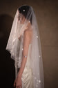 Profile of a bride under a two-tier star tulle wedding veil with blusher forward, stars catching the light, Celestial Glow Veil