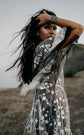 Bride with hand in her hair in a star lace wedding dress over black tulle, sheer sleeve lifted by the wind, ASH Counting Stars