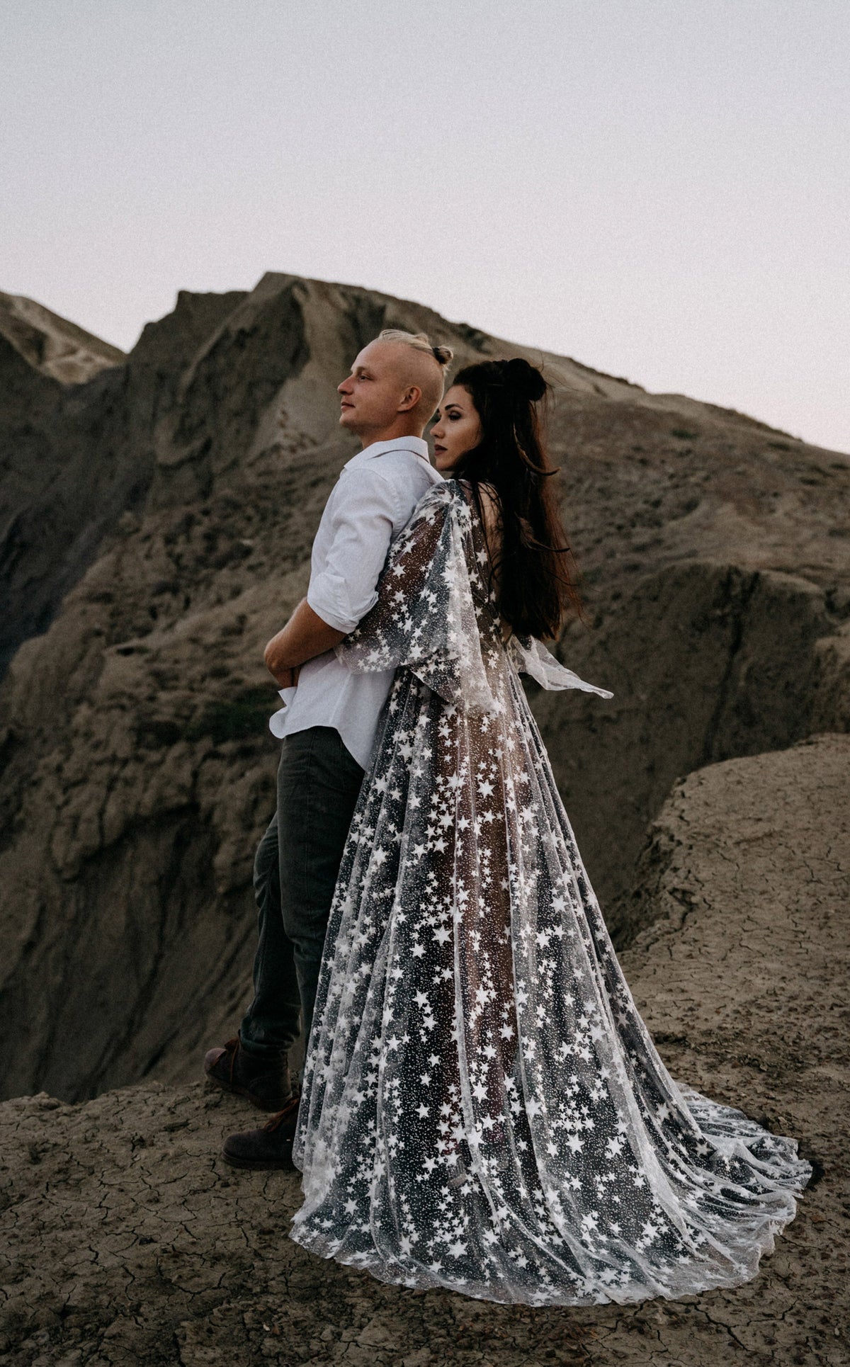 Elopement couple on a rocky ridge, bride in a black and ivory star lace wedding dress with a long train, ASH Counting Stars