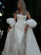 Bride glancing aside at dusk in an ivory bridal cape, puff sleeves and starry train worn over a satin corset gown, Aura Cape