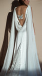 Studio back view of a satin wedding dress with cowl back, blue embroidered butterfly and stars on the train, Aurora