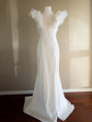 Full-length sample wedding dress on a dress form, ivory stretch crepe fit and flare with tulle ruffle straps and short train, Celeste Sample
