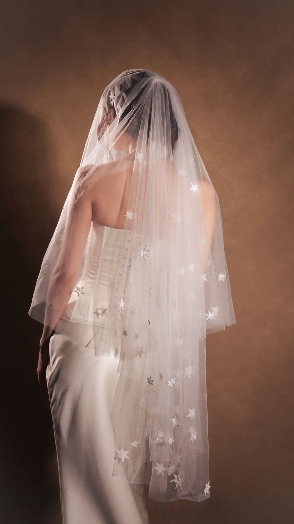 Back view of a star wedding veil in two tiers, stars scattered across sheer tulle over a corset back, Celestial Glow Veil