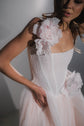 Detail of a dropped corset bodice with hand-dyed silk flowers on the strap and waist of a blush wedding dress, Chrysanthemum