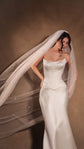 Long tulle wedding veil with hand-placed stars blowing to one side of a bride in a satin corset gown, studio, Coastal Moonlight Veil
