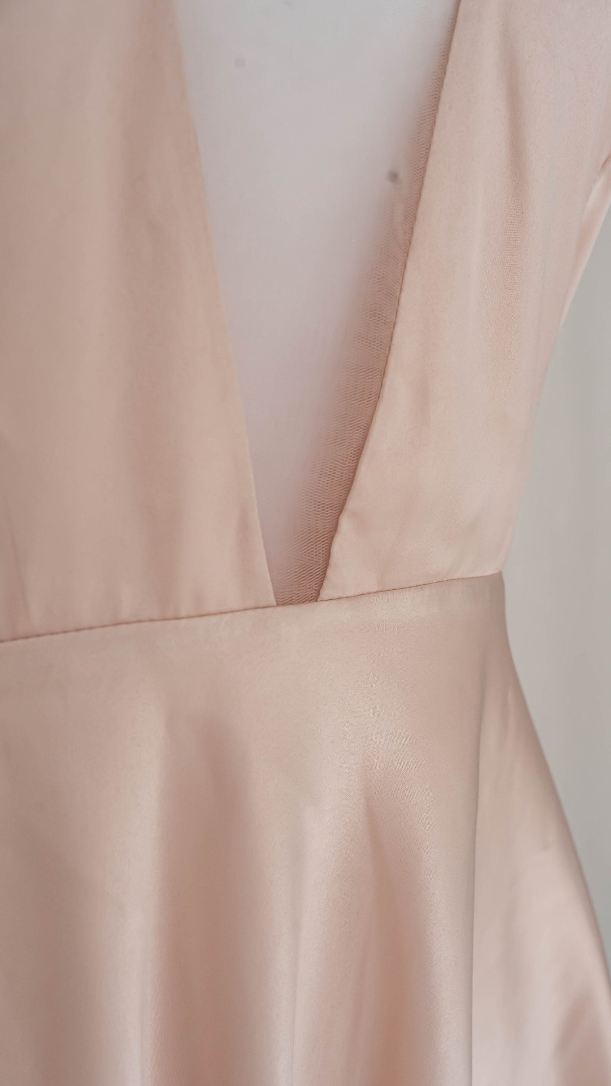 Detail of the deep V-neck blush satin lining under a short star lace wedding dress, dress form, Cosmic Dancer