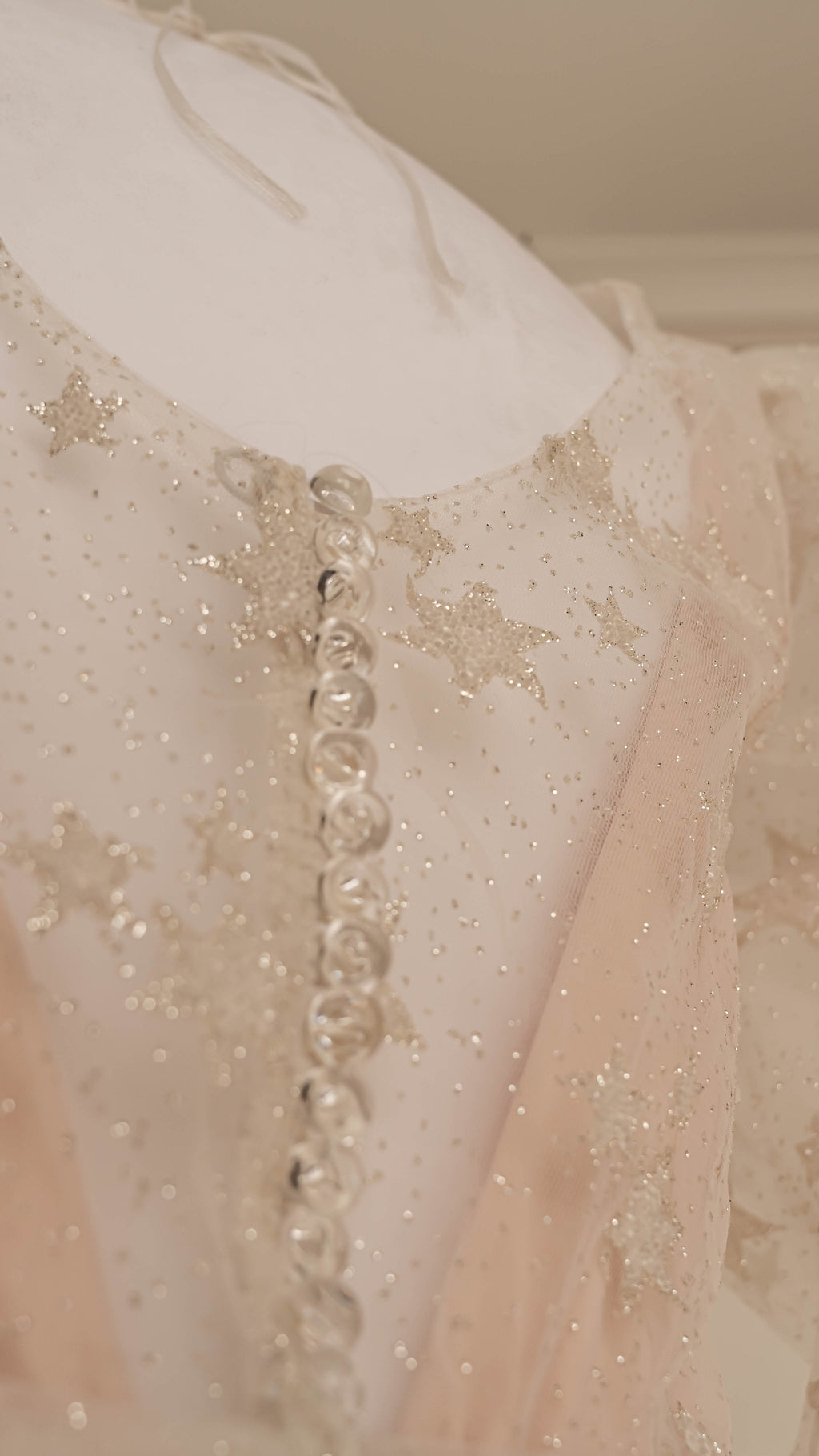Back detail of a star lace mini wedding dress with a row of covered buttons and glitter tulle, Cosmic Dancer