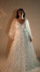 Front view of a star lace wedding dress with a V-neck satin slip, long sheer sleeves and full skirt, warm studio light, Counting Stars 2.0