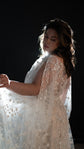 Side view of a bride against a black backdrop, backlit star lace sleeve of a wedding dress glowing, Counting Stars 2.0