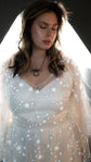 Close-up of a bride with eyes closed, stars scattered across the sheer lace bodice of a wedding dress, Counting Stars 2.0
