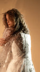 Over the shoulder view of the covered back and translucent buttons on a sheer star lace wedding dress, Counting Stars 2.0