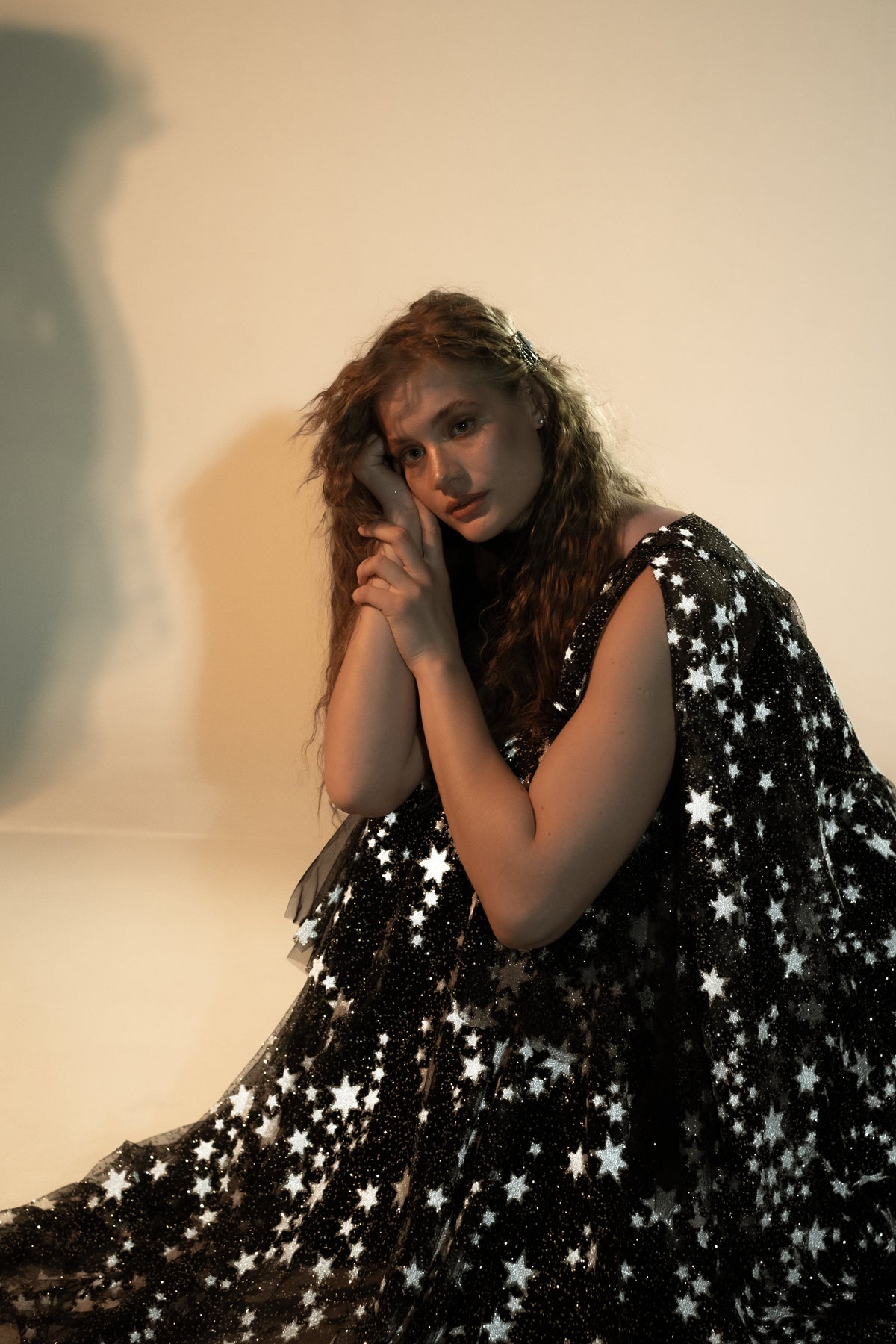 Bride sitting on the floor in a black starry wedding dress, star lace skirt spread around her, Counting Stars Black