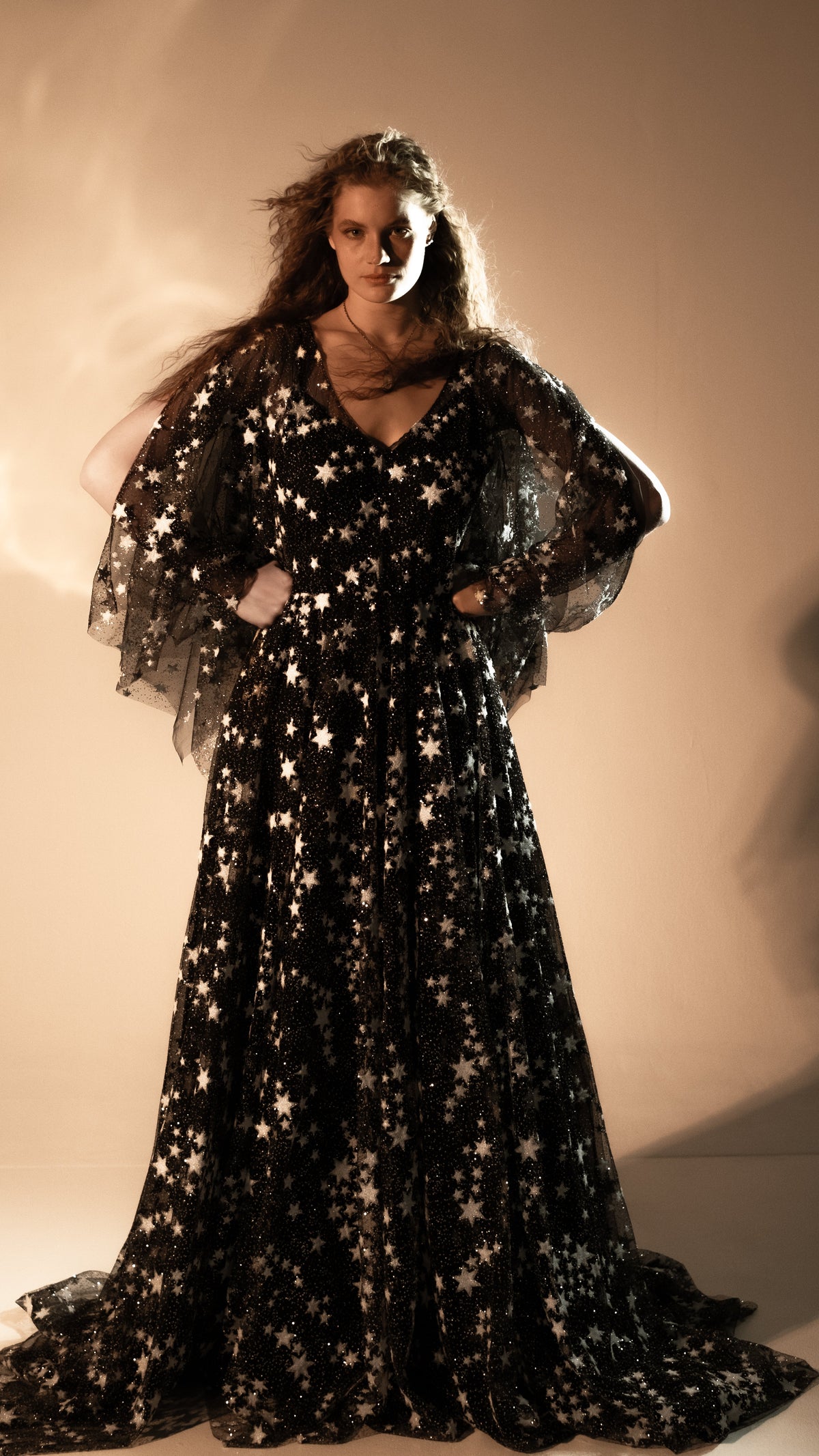 Full-length black celestial wedding dress with star lace skirt and train, hands on hips, Counting Stars Black