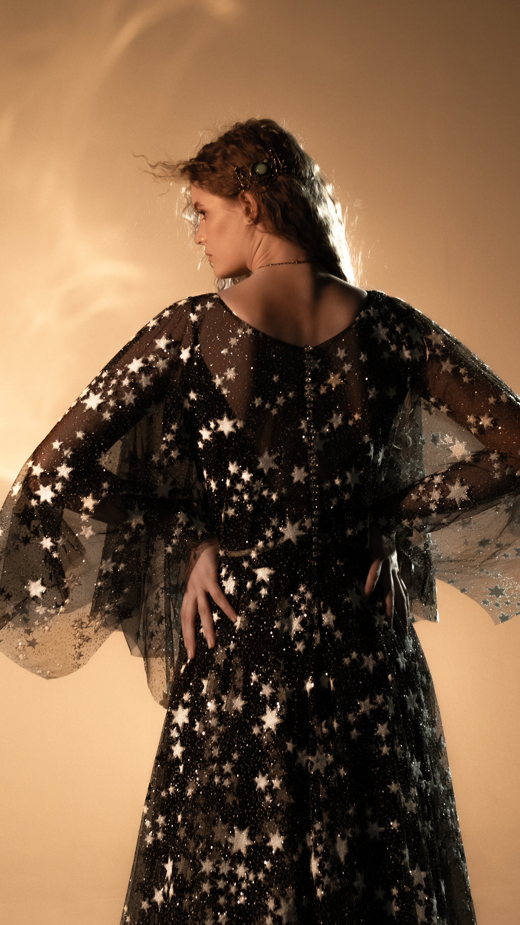 Back of a black star lace wedding dress with button closure and sheer cape sleeves, Counting Stars Black