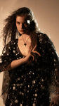 Close-up of the V-neckline and reflective star lace on the Counting Stars Black whimsigoth wedding dress