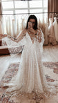 Mirror selfie in a bridal boutique, star lace wedding dress with sheer cape sleeves over a V-neck slip and long train, Counting Stars Sample