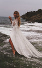 Bride standing in rushing seawater with a high slit showing, long sleeve star lace wedding dress, Counting Stars Sample