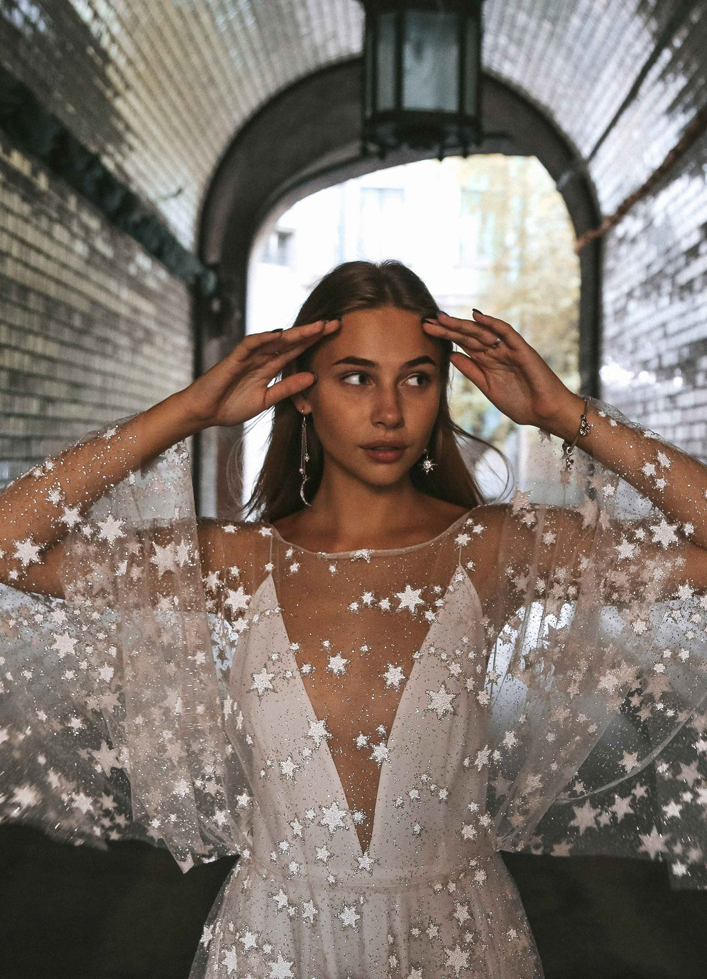 Waist-up shot in a tunnel, sheer star lace wedding dress with a plunging V-neck and wide sleeves, Counting Stars Sample