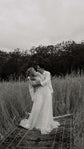 Black and white shot of a couple in tall grass on a rug, bride in a long star lace wedding dress, Counting Stars Sample