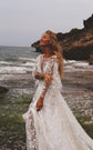 Bride laughing on a seaside rock in a long sleeve star lace wedding dress, waves and cliffs behind, Counting Stars