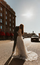 Couple kissing on a city street in sunlight, long star lace wedding dress train spread across the road, Counting Stars
