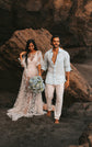 Elopement couple on a rocky beach, bride in a sheer star lace wedding dress holding blue hydrangeas, Counting Stars