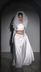 Two-piece silk satin wedding dress, long sleeve crop top and bias skirt with crossed waist ties, short tulle veil, studio arch. Danielle by Ephemeris