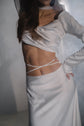 Close crop of a draped satin crop top and bridal skirt with thin ties crossing the bare waist, Danielle
