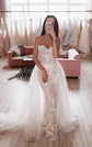 Lace mermaid wedding dress with thin straps, beige lining and a full tulle overskirt, mirror selfie in a bridal studio. Feathers Sample by Ephemeris