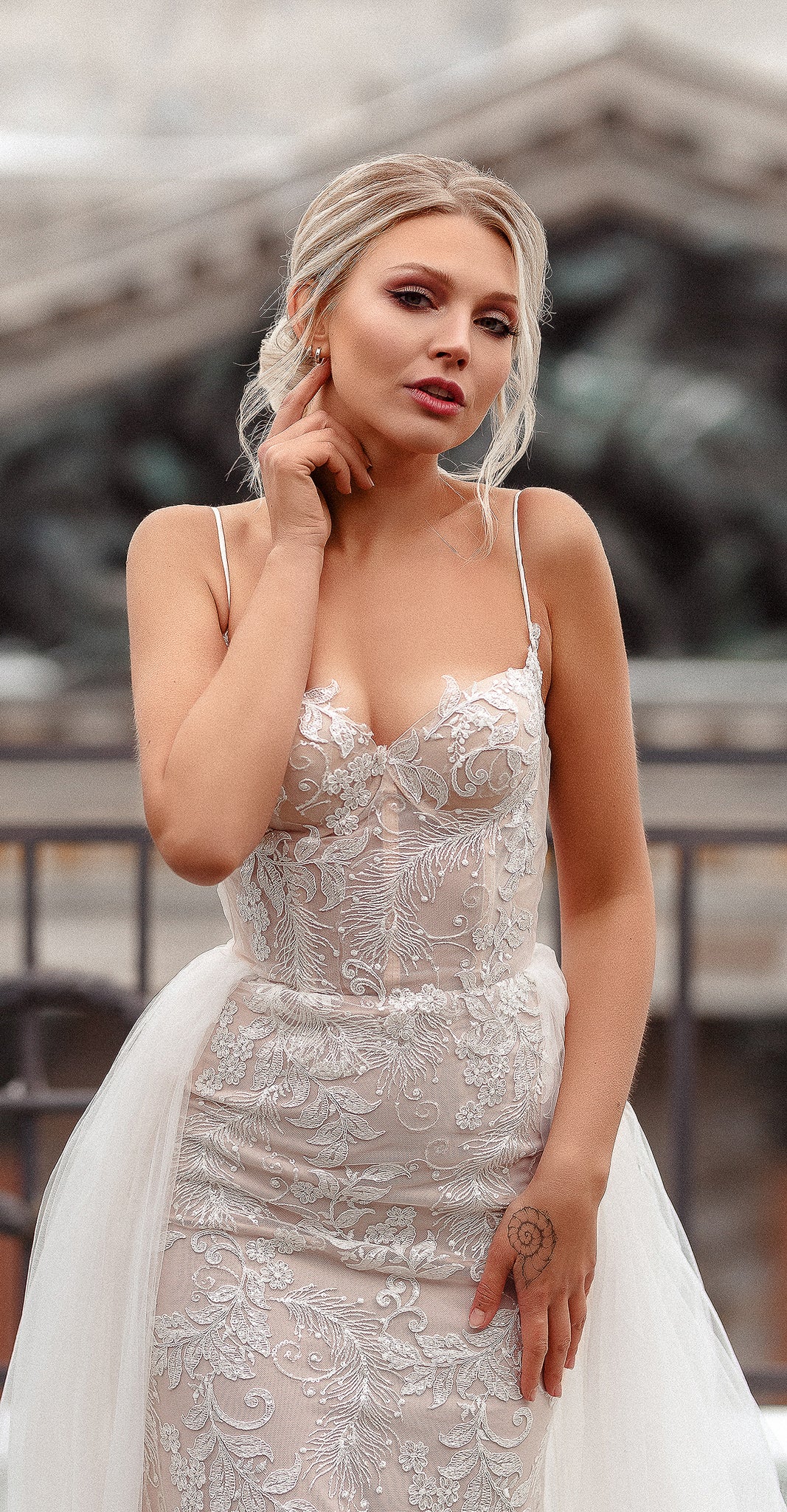 Waist-up portrait of a lace wedding dress with sweetheart neckline, thin straps and tulle at the hips, Feathers Sample