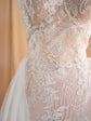 Close-up of feather and leaf corded lace appliques over a beige lining on a fitted wedding dress, Feathers Sample