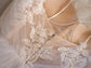 Close-up of lace leaves and sequin detail beside the structured cup of a wedding dress bodice, Feathers Sample