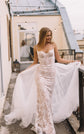 Front view of a fitted lace wedding dress with sweetheart cups and a tulle overskirt spread wide, Feathers Sample