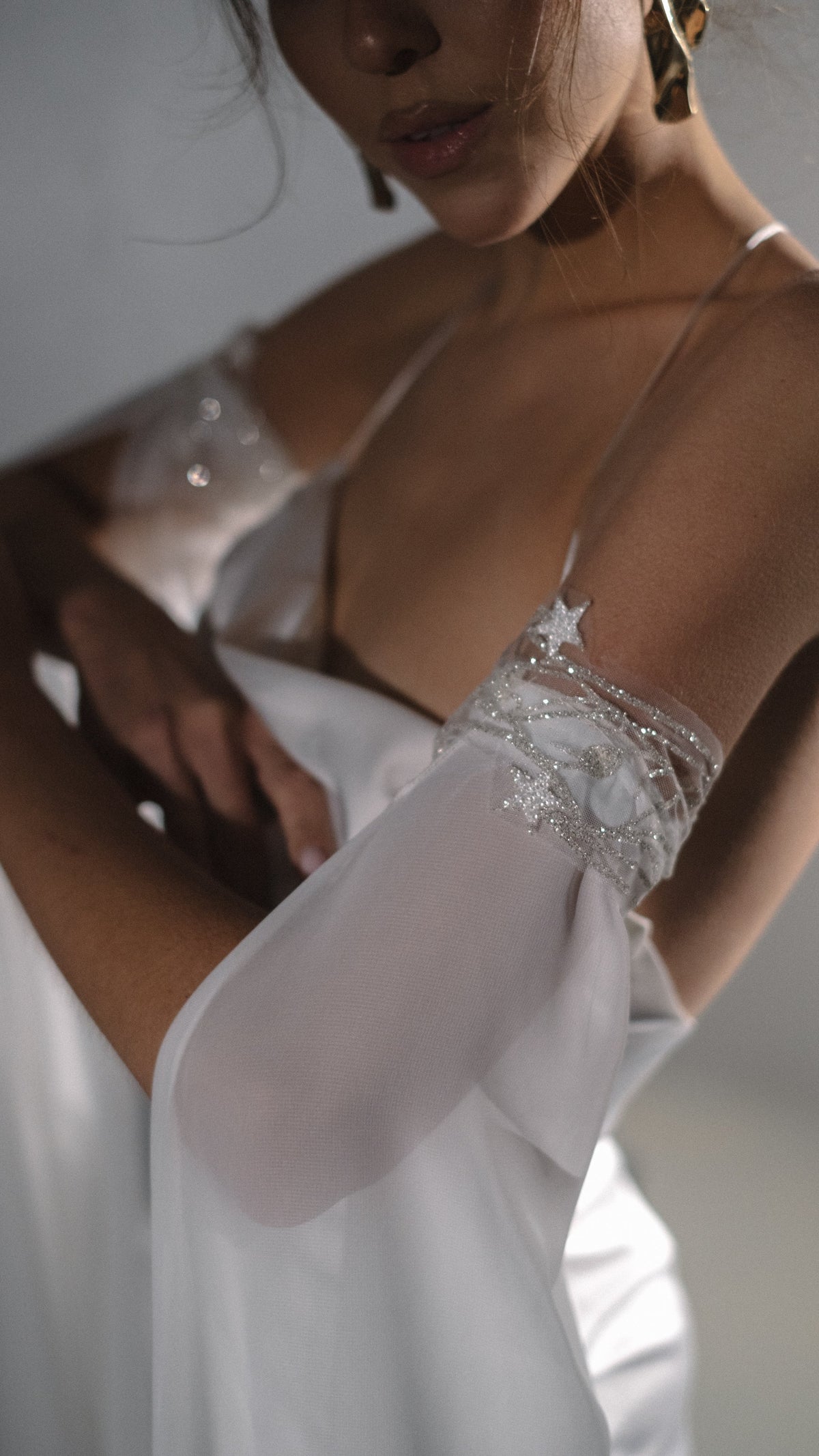 Detachable sleeves in soft ivory chiffon with starry lace vines at the upper arm, worn with a cowl neck slip gown. FEYRE Sleeves by Ephemeris