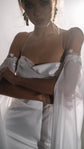 Bride hugging her arms, draped cowl neckline of a silk wedding dress with beaded lace sleeve cuffs, FEYRE