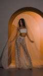 Front view of star lace bridal pants with a white crop top and a long tulle veil pooling behind, Galactic Outlaw