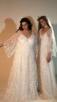 Two models in pale wedding dresses, one in star lace with flutter sleeves and one in glitter lace with a choker, studio, Galaxy Champagne 2.0