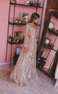 Bride in a pink boutique beside shoe shelves, champagne glitter lace wedding dress with long sleeves and a pooled train, Galaxy Champagne