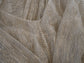 Fabric detail of ivory glitter lace with wavy gold-toned threads and a row of small buttons on the sample wedding dress, Galaxy Ivory Sample