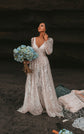 Boho bride in a sea cave holding blue hydrangeas, V-neck ivory glitter lace wedding dress with puffed sleeves, Galaxy Ivory
