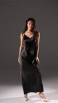 Black long slip dress with a V neckline and thin straps, shown as the second colour option, white heels, Infinity Slip Ivory