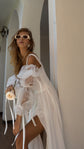 Waist-up crop of off-shoulder organza puff sleeves on a strappy chiffon wedding dress, bride holding a rose, pearls, LUNA