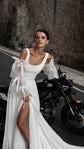 Close crop of a bride by a motorbike, square neck and wide straps of a chiffon wedding dress with ribbon-tied puff sleeves, LUNA