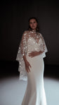 Bride in a studio spotlight wearing an ivory star bridal cape over a strapless mermaid gown, Lunar Eclipse Cape Ivory
