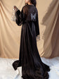 Back view of a black bridal robe with a long train, butterfly embroidery and starry sleeves, bride standing on white sheets, Metamorphosis Robe Black
