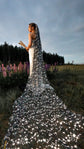 Black star wedding veil with a long train across a wildflower field of lupines, bride holding dried flowers, Milky Way Veil Black
