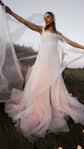 Bride spreading a sheer super organza mantilla veil wide in a lupine meadow at dusk, Moonglade wedding veil