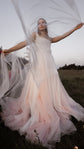 Ultra-light super organza veil lifted by the wind over a bride's head, low-angle outdoor bridal portrait, Moonglade