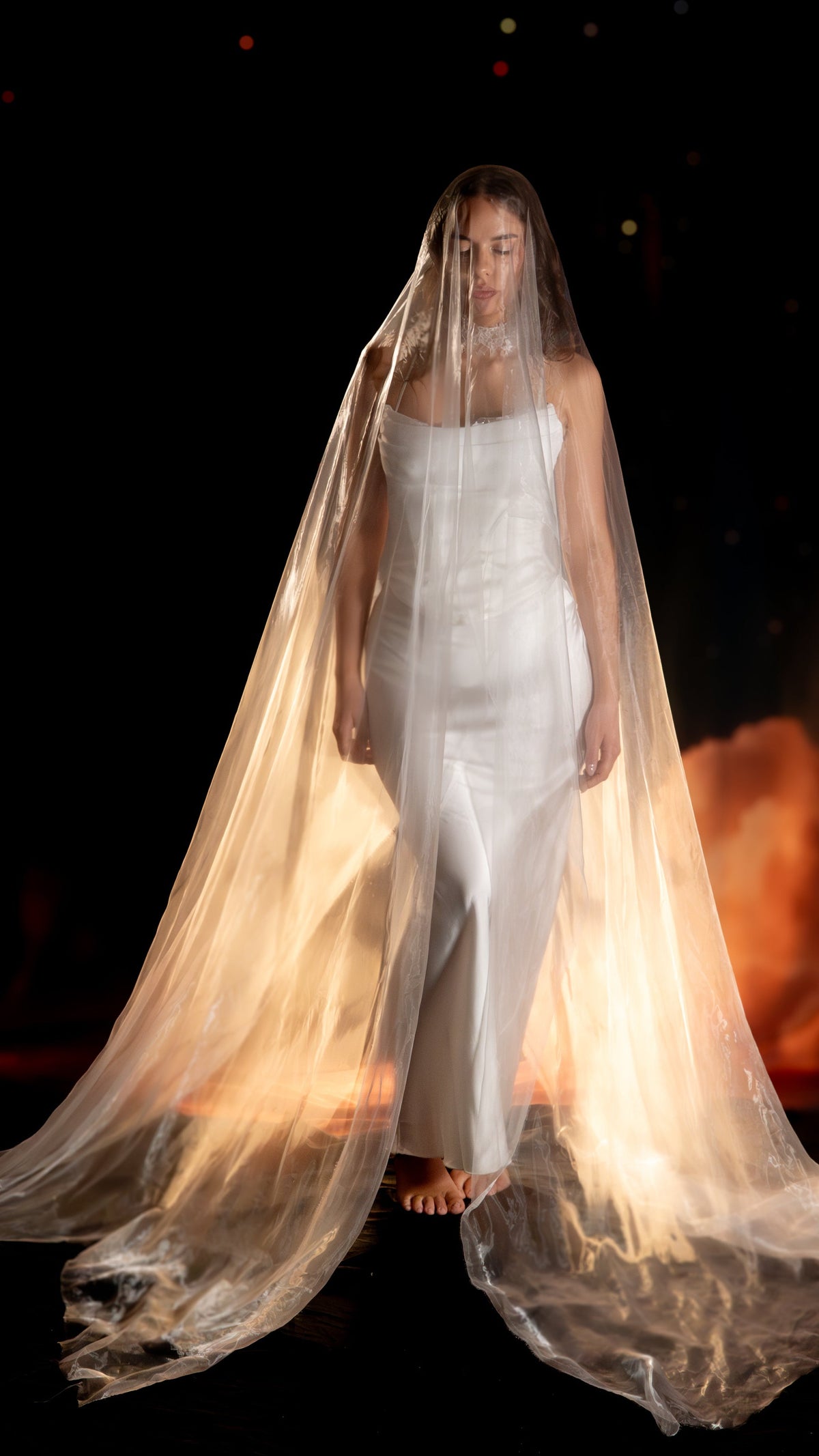 Floor-length sheer super organza veil covering a barefoot bride in a satin slip dress, lit warm from behind, Moonglade